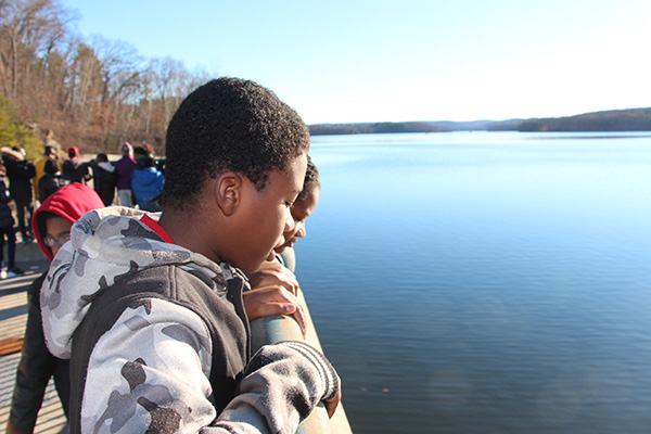 Students peer down at the Cross River Reservoir, which is fed by the Cross River.