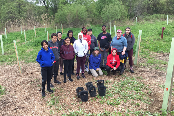 A group of Ossining High School students and their teacher Danielle Jackson, along with Tyler Van Fleet, feeling very accomplished after planting 23 trees.