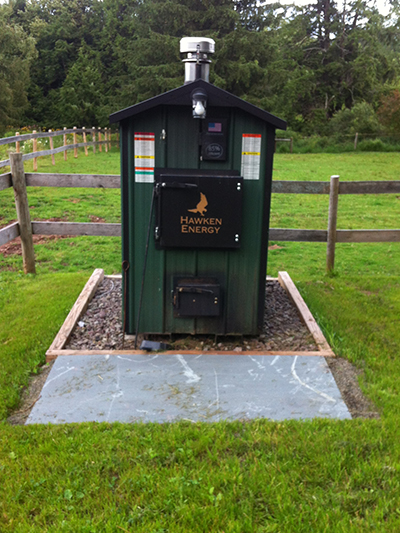 The Hawken wood furnace installed with added bluestone slab in front.