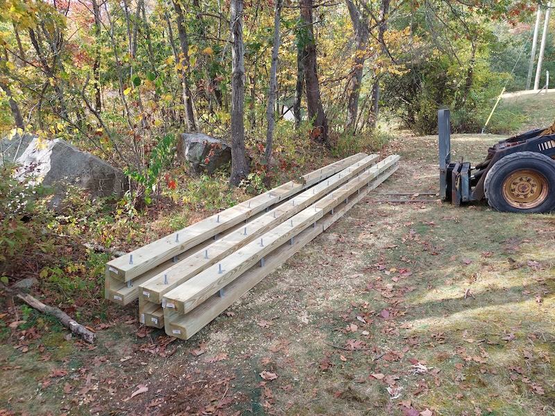 Ready-to-install culverts. Three open-top box culverts: long three-sided wooden boxes with steel bars inside to stabilize the sides.