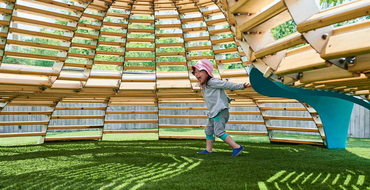 NEST playscape at the Brooklyn Children’s Museum. A child delighted by the NEST playscape at the Brooklyn Children’s Museum.