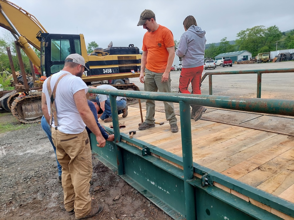 A group of people put the last nuts and bolts into place.