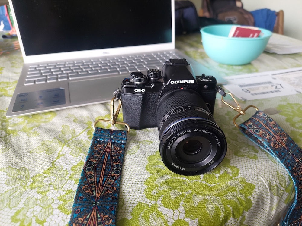 Olympus OM-D camera. An Olympus OM-D camera with a telephoto lens.