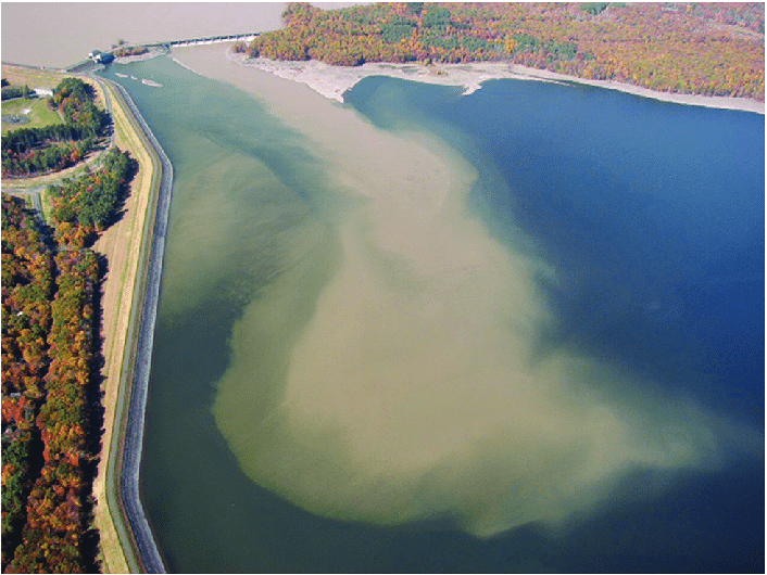 Sediment plume in reservoir. Plume of turbid water entering the east basin of New York City's Ashokan Reservoir following an extreme runoff event. The increase in extreme precipitation events in many regions of the world will decrease UV transparency, the potential for solar disinfection of parasites and pathogens, and increase the cost of effective disinfection of drinking water sources. Photo taken by Randall Hurlbert.